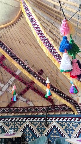 The interior of a traditional yurt with national ornaments and bright tassels