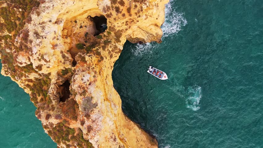 Ponta da Piedade Headland, Golden Rocks, Cliffs, Atlantic Ocean on Sunny Day. Aerial Overhead Shot. Algarve, Portugal. Moving Upwards