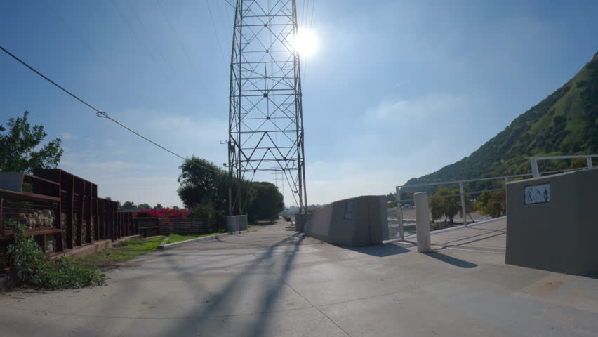 Riding across a Los Angeles river pedestrian, horse and bike bridge near Griffith Park and Glendale in Los Angeles California.  
