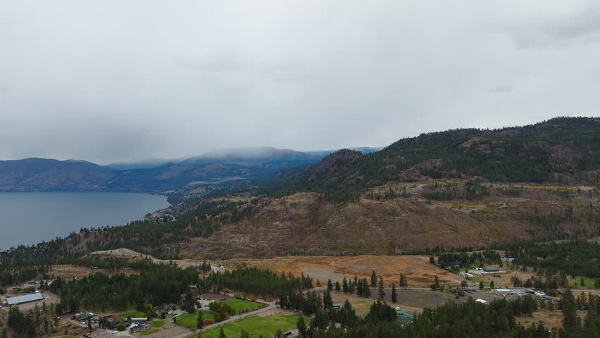 Aerial view of mountains and lake on an overcast day