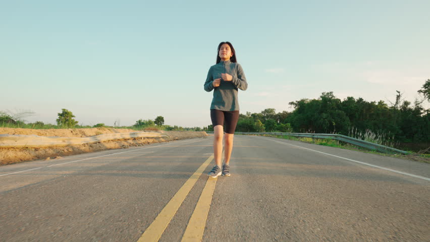 Teenage Girls running in country road.
