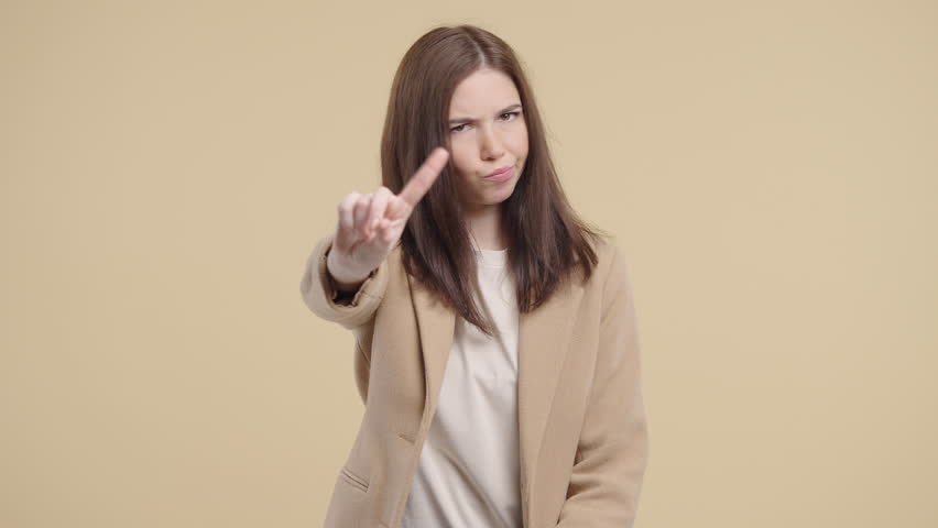 Disappointed Businesswoman Wagging Finger in Disapproval Saying No Gesture. Dissatisfaction, disapproval, firm rejection, conveying authority, boundaries, professional judgment.