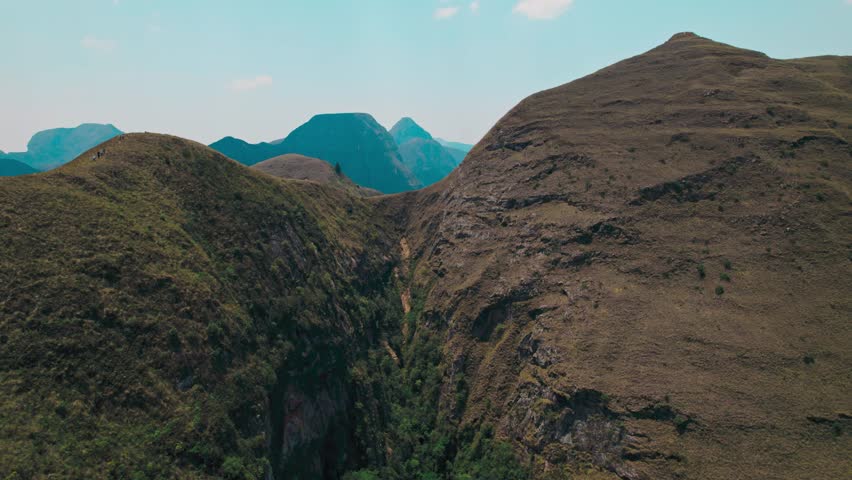 A breathtaking wide-angle shot capturing the extensive, dry, and rugged mountain landscape of the Codo de los Andes in Bolivia.