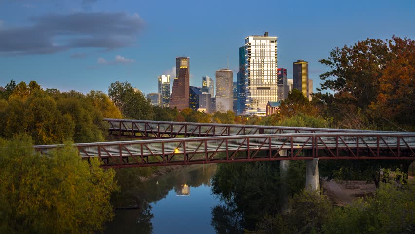 Timelapse of Houston downtown skyline at sunset as clouds move and business city light turn on, modern skyscrapers, urban traffic, and day to night in of Houston downtown, Texas, United States USA