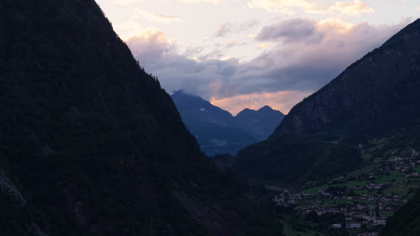 Moody Blue Hour Over Swiss Alps with Low Clouds in a long valley in Swizterland