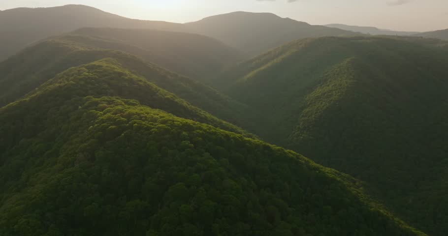 Sunset over lush mountains in West Virginia, peaceful and serene view
