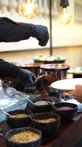 A chief puts nuts ice creams, close up shot, insert shot