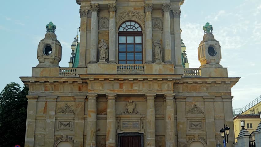 Low angle view showing baroque facade stone sculptures, towers in Warsaw Poland