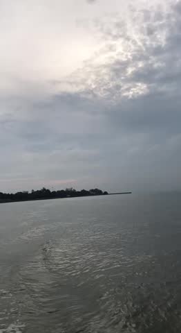 River scenery with water waves viewed from a moving boat