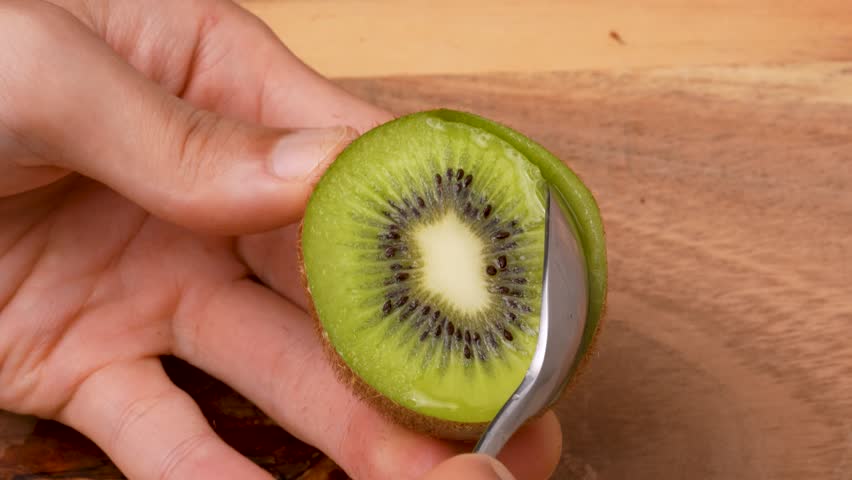 Video of hollowing out a kiwifruit with a spoon.