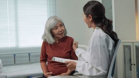 Elderly asian woman explaining her stomach ache symptoms to a friendly female doctor in a clinic - Powered by Shutterstock - Get 15% off with code: PIKWIZARD15