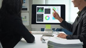 Two business professionals analyzing financial graphs and data charts during a meeting in the office - Powered by Shutterstock - Get 15% off with code: PIKWIZARD15