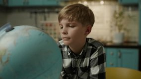 Boy Examining Globe at Home - Powered by Shutterstock - Get 15% off with code: PIKWIZARD15