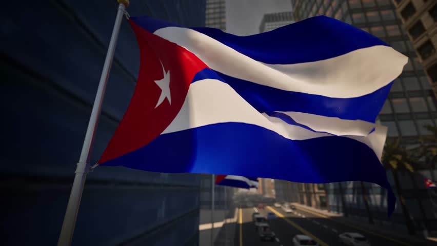 The national flag of Cuba waves clearly along a modern city street during bright daylight, standing out against a contemporary urban environment. Natural sunlight enhances the red triangle, blue and white stripes, and the white star, reinforcing strong national symbolism and visual clarity. The surrounding cityscape features organized streets, modern buildings, and light traffic, reflecting everyday urban life within a Caribbean and Latin American setting.

The composition avoids highlighting specific landmarks, allowing the scene to represent Cuba in a broad and adaptable manner. Gentle movement of the flag adds realism and visual rhythm, while daylight conditions emphasize balance, openness, and neutrality. The urban environment appears calm and functional, making the visual suitable for a wide range of informational and media uses.

This scene effectively conveys themes of national identity, civic presence, and modern city life. It is well suited for international news coverage, travel-related storytelling, cultural features, or background visuals that require a professional and unbiased representation of Cuba.
