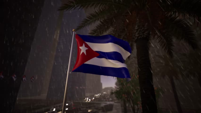 The Cuban national flag waves during rainfall along a modern city street, creating a moody and atmospheric urban scene. Wet road surfaces reflect surrounding buildings and lights, adding depth and texture to the composition. The movement of the flag contrasts with falling rain, reinforcing themes of resilience and continuity within the city environment.

Cloudy skies and subdued lighting contribute to a calm and neutral mood, while the structured urban layout maintains clarity and balance. The scene avoids recognizable landmarks, allowing it to represent Cuba broadly for global audiences.

This visual supports storytelling related to weather, urban life, international news, or cultural representation. Its realistic details and professional composition make it suitable for editorial media, informational platforms, and general visual narratives involving modern cities.
