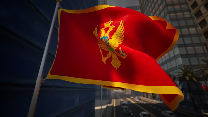 The national flag of Montenegro waves prominently along a modern city street during bright daylight, standing out against a structured and contemporary urban environment. Sunlight enhances the deep red color of the flag and highlights its golden emblem, reinforcing its strong national symbolism. The surrounding cityscape features clean architecture, organized streets, and light traffic flow, creating a realistic and balanced urban setting.

The composition avoids highlighting specific landmarks, allowing the scene to represent Montenegro in a general and adaptable way. The gentle movement of the flag adds realism and visual rhythm, while daylight conditions emphasize clarity, openness, and neutrality. The urban environment appears calm and functional, supporting a wide range of informational and editorial contexts.

This scene effectively conveys themes of national identity, civic presence, and modern European city life. It is well suited for international news coverage, travel-related storytelling, cultural features, or background visuals requiring a professional and unbiased representation of Montenegro.
