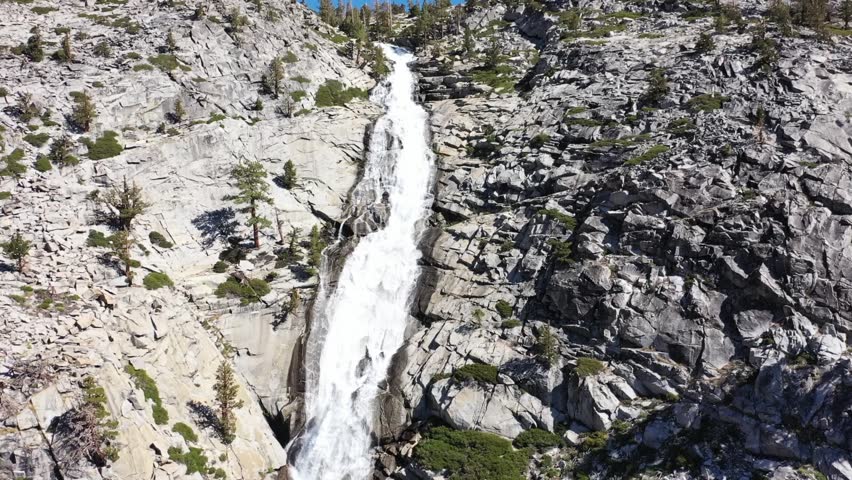Drone footage flyover of large waterfall off of highway 50 near Tahoe CA. Camera follows the waterflow as it flows down. Horsetail Falls.