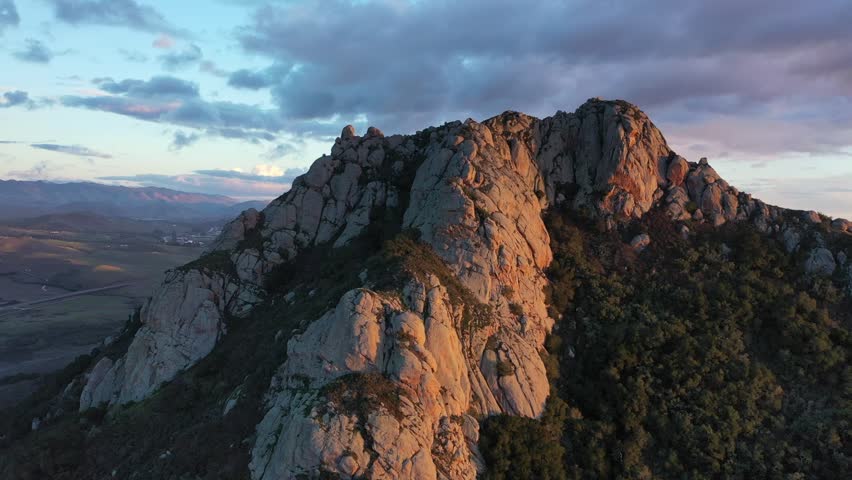 Partial orbit shot of a mountain peak during sunset near Morro Bay, CA.