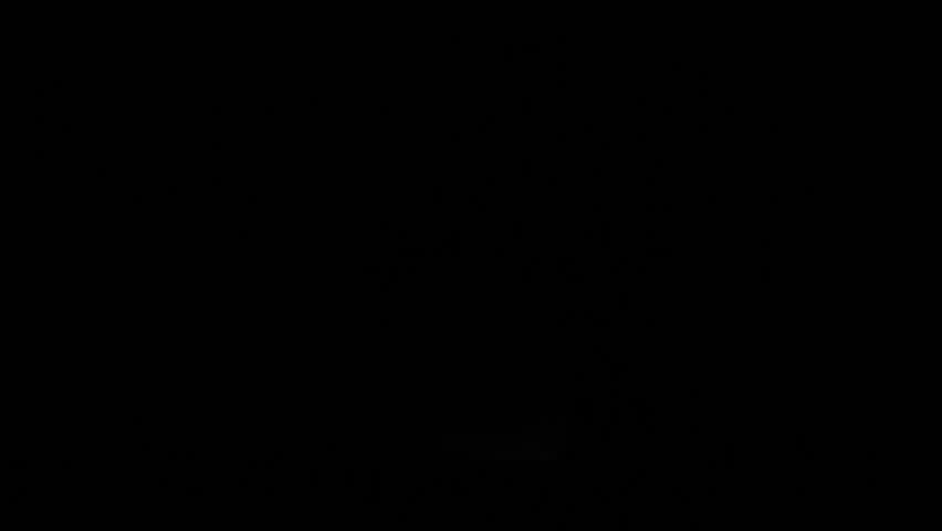 A car driving beyond the horizon on a road with fog creating an illuminated spooky silhouette of the landscape. Traffic background