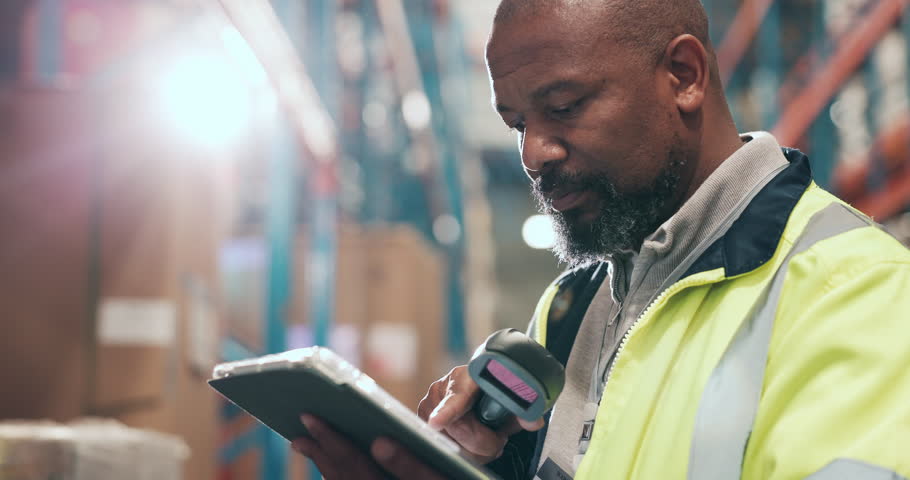 Shipping, tablet and black man in warehouse with barcode scanner for stock, inventory or check cargo. Technology, distribution and mature person with storage update, logistics reader and flare