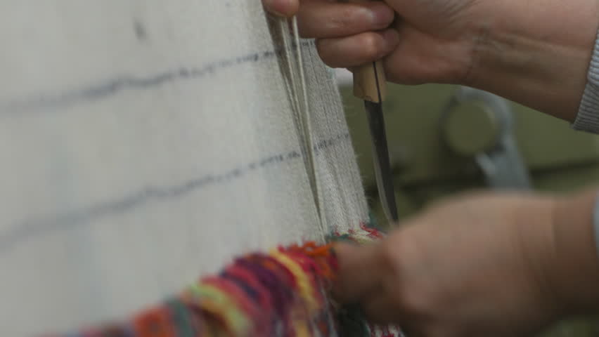 Expert artisan weaving traditional carpet