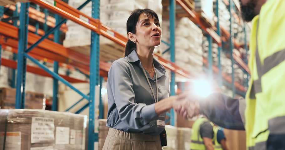 Collaboration, handshake and management with people in logistics warehouse for success or support. Greeting, thank you or welcome with supply chain team shaking hands in factory for delivery target