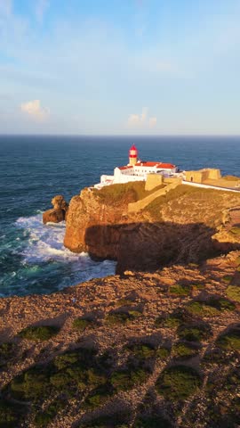Cape Saint Vincent, Sao Vicente Lighthouse and Atlantic Ocean on Sunny Morning. Aerial View. Sagres, Algarve, Portugal. Moving Forward. Vertical Video