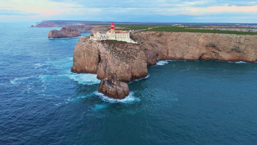 Cape Saint Vincent, Lighthouse, Cliffs and Atlantic Ocean in Evening Twilight. Aerial View. Sagres, Algarve, Portugal. Moving Forward