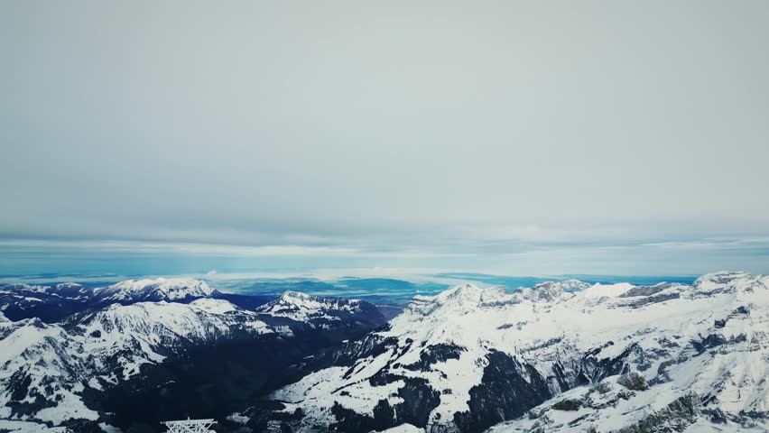 Snow rocky mountain peaks and range at Titlis, Engelberg, Swiss Alps. Panorama of picturesque nature landscape of Switzerland mountains. Mount Titlis over Engelberg on Swiss Alps