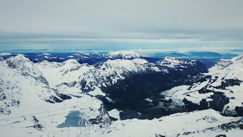 Alps mountain landscape. Panorama of snowy rocky mountains in Switzerland. Mountains in Engelberg ski resort. Winter sport activity. Travel and tourism concept. Landscape of Alps