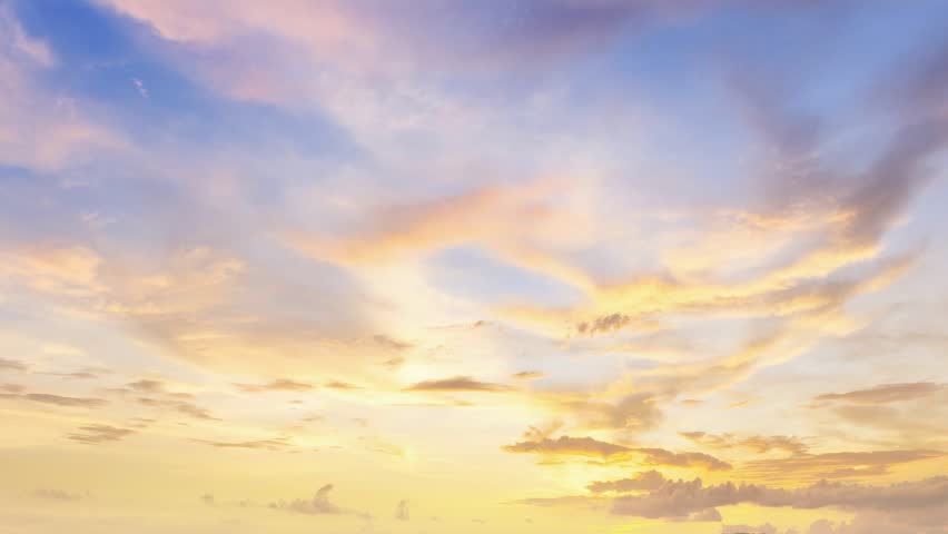 Soft golden sunset sky with calm clouds creating peaceful atmospheric scene. seamless looping 4k video background
