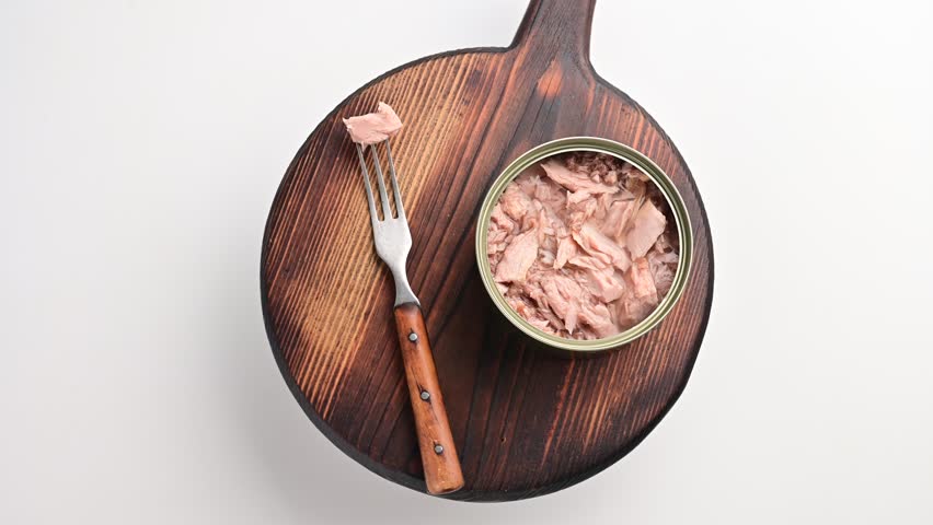 How to prepare tuna salad using canned tuna on a wooden board with fork