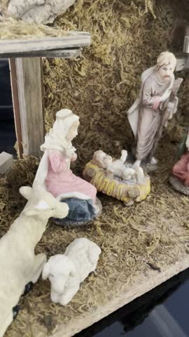 Realistic Clay Figurine Nativity Scene Depicting Birth of Jesus in Traditional Christmas Setting