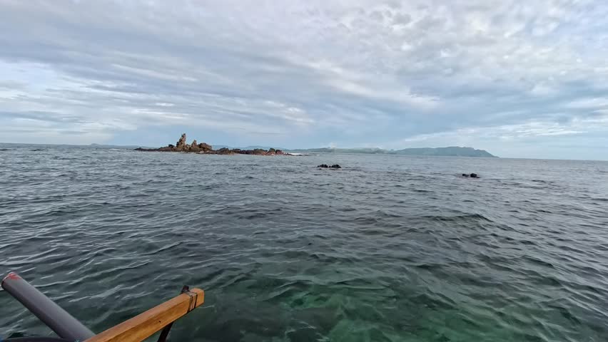 Stunning Coastal Landscape Featuring Lush Green Hills and Tranquil Waters Under a Cloudy Sky