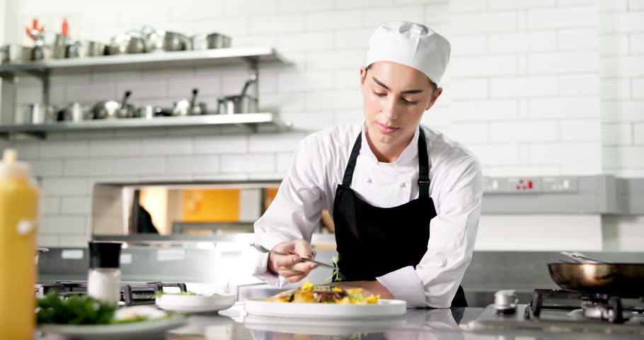 Plate, woman and chef in kitchen for cooking at restaurant for meal preparation, presentation or garnish. Food, hospitality career and female culinary worker for cuisine flavor with catering at diner