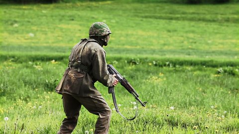 Soldier runnning on grassland – Stockvideo