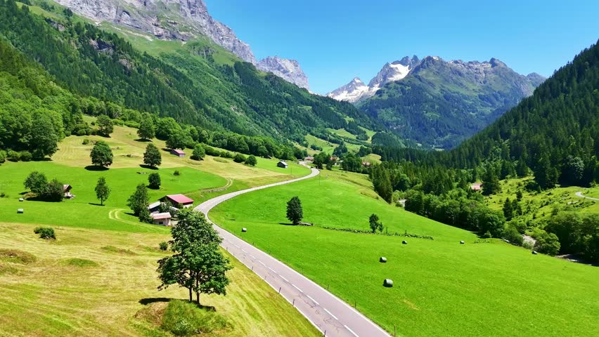 Drone Switzerland 4k. Swiss Alps valley country side road in summer. Switzerland tourism roadtrip destination.