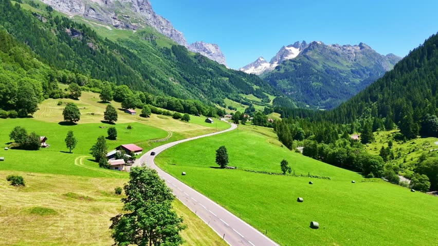 Drone Switzerland 4k. Swiss Alps valley country side road in summer. Switzerland tourism roadtrip destination.