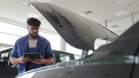 Mechanic using a tablet for car diagnostic in a workshop - Powered by Shutterstock - Get 15% off with code: PIKWIZARD15