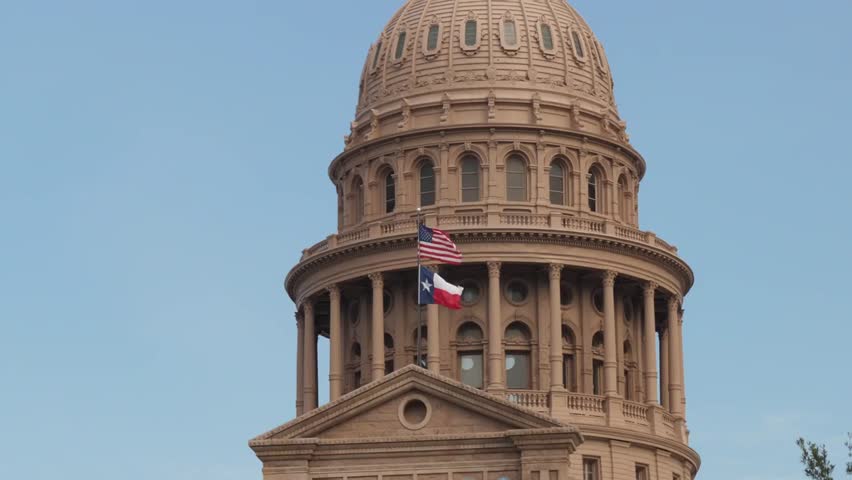 Close-up daytime exterior of the Texas State Capitol dome in downtown Austin, showcasing historic architecture, government buildings, and city landmarks.