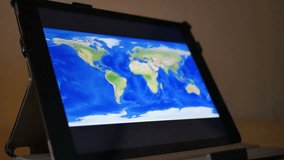 Close-up of a person exploring a world map on a tablet PC, illustrating technology, travel planning, and digital navigation. - Powered by Shutterstock - Get 15% off with code: PIKWIZARD15