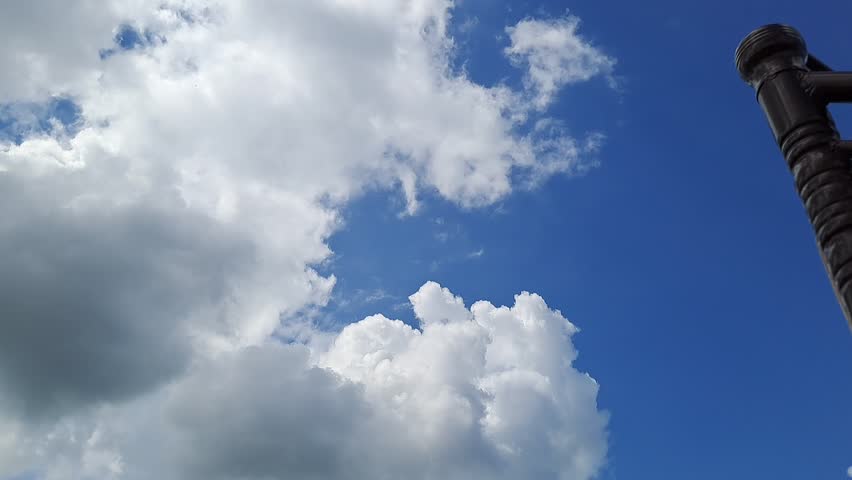 A captivating high-definition slow-motion capture of a cloudy sky. The reduced speed emphasizes the massive scale, rich texture, and fluid, almost hypnotic movement of the cloud formations as they drift across the frame. This cinematic footage is perfect for use as an atmospheric background, a dramatic transition, an establishing shot for weather segments, or to convey moods ranging from tranquil and dreamlike to ominous and epic, depending on the context.