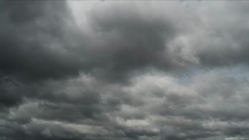Timelapse footage of dark storm clouds moving rapidly across the sky, creating a dramatic atmosphere and illustrating changing weather conditions.