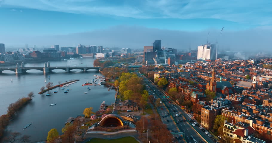 Lively panorama of modern Boston, Massachusetts with heavy traffic on the roads. Thick smog spreads over the city view. Aerial perspective.