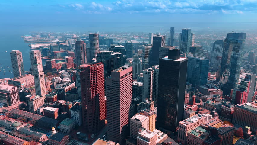 Dense urban area built up with high buildings. Drone footage over the downtown of Boston, Massachusetts, USA. Smog coats the view on the city.