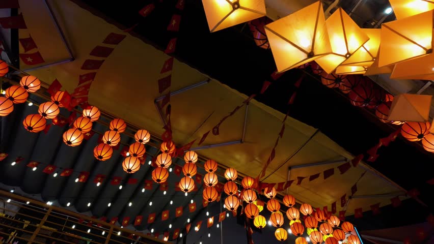 Brightly colored traditional lanterns and vietnamese flags decorating a bustling street in the old quarter of hanoi, vietnam, creating a festive and magical atmosphere during an evening celebration