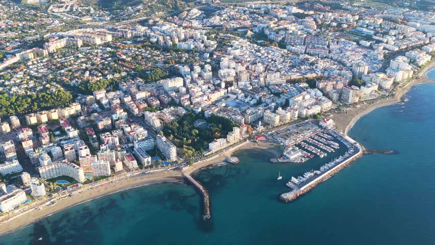 Golden Dawn in Marbella: Stunning Aerial Sunrise View of Luxury Resorts, the Coastal Promenade, and Pristine Mediterranean Beaches on the Costa del Sol