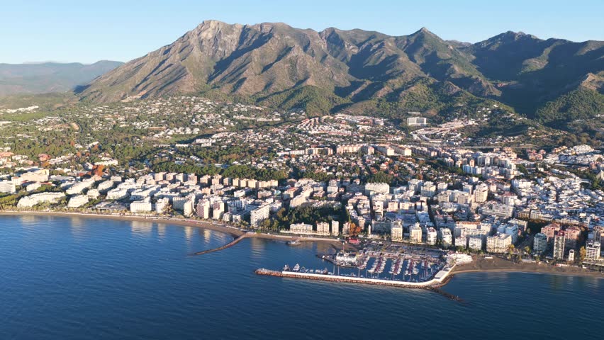 Golden Dawn in Marbella: Stunning Aerial Sunrise View of Luxury Resorts, the Coastal Promenade, and Pristine Mediterranean Beaches on the Costa del Sol