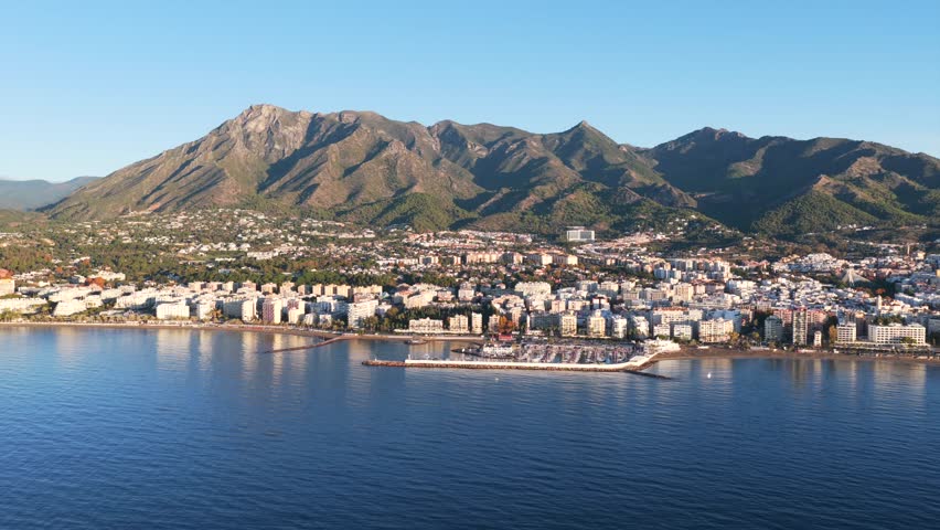 Golden Dawn in Marbella: Stunning Aerial Sunrise View of Luxury Resorts, the Coastal Promenade, and Pristine Mediterranean Beaches on the Costa del Sol