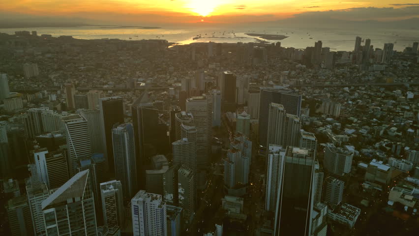 Aerial view of skyscrapers buildings in Makati business district and Manila city at sunset, capital of Philippines, 4k